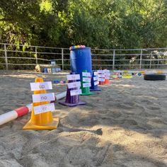 there are many cones and markers in the sand