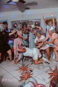 a group of people standing around each other on a dance floor