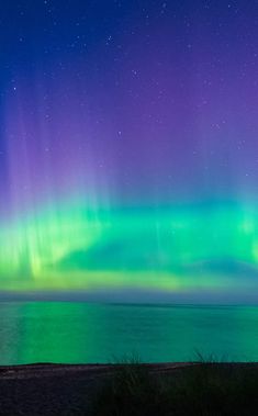 an aurora bore is seen over the ocean