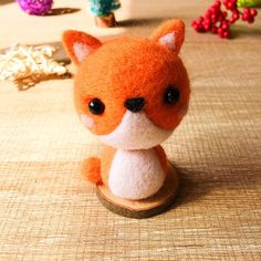 an orange and white stuffed animal sitting on top of a table