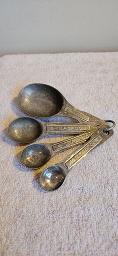 four spoons are sitting on the floor next to each other