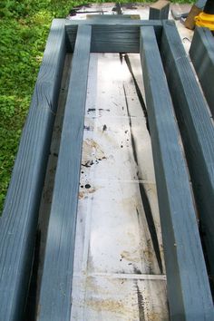 an old wooden bench sitting in the grass