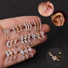 several different types of ear piercings on someone's hand with the same design