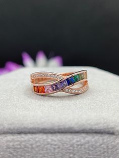 Rainbow Stone Band, Channel Setting Rainbow Band, Multi Color Band, Cross Over Rainbow Band, Criss Cross Ring, Rose Gold Ring, Channel Set Pave Band, Engagement Rings, LGBT Colorful Ring, Proposal Ring, Anniversary Gifts, Gifts for Girlfriend, OneSoulJewellery * Center Stone Details: - ↣Stone- Cubic Zirconia ↣Shape - Princess ↣Color- Rainbow ↣Clarity- VVS ↣Cut- Brilliant ↣Making Process - Handmade by Skilled Craftsmen. Note- All the Product have excellent Sparkle Camera does not make justice to it. * Other Stone Details: - ↣Stone- Moissanite  ↣Shape - Round ↣Color- Colorless ↣Clarity- VVS ↣Cut- Round Brilliant Note- {Customization Available} * Ring Details: - ↣Brand- One Soul Jewellery ↣Metal purity- Solid Gold (10KT,14KT,18KT) / Silver 925. ↣Metal Color- White, Rose, Yellow. ↣Stamp/Hallma Rainbow Engagement Ring, Rainbow Wedding Theme, Colorful Ring, Rainbow Band, Rainbow Stone, Criss Cross Ring, Ring Proposal, Channel Setting, Pave Band