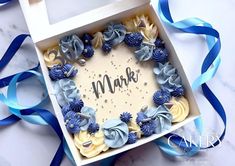 a box that has some blue and yellow flowers in it with the word mark on it