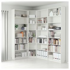 a white book shelf filled with lots of books