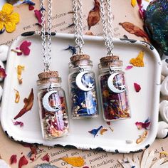 three glass jars filled with different types of items on top of a white platter