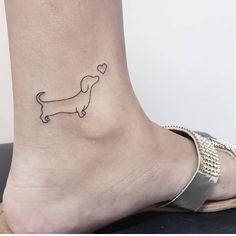 a small dachshund tattoo on the ankle