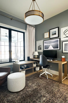 a living room filled with furniture and a large flat screen tv mounted to the wall