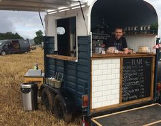 a man standing in the back of a food truck