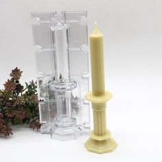 a yellow candle is next to some clear containers