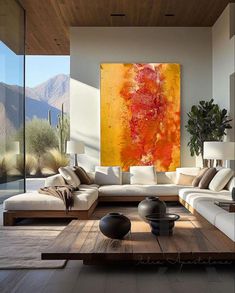 a living room filled with furniture and a large painting on the wall