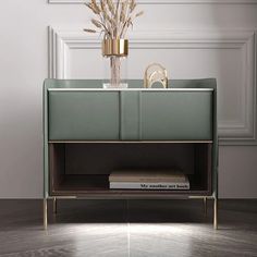 a modern sideboard with flowers and books on it