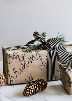 a wrapped present with a pine cone on the side