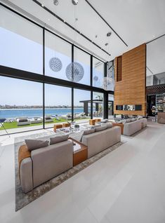 a living room with large windows overlooking the water