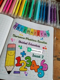 an open notebook with colored pencils and numbers