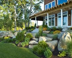 landscaping with rocks and plants in front of a large house on a sunny day that has the words great front yard landscape hacks that are great