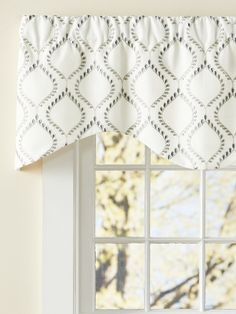 a window with a white and black valance