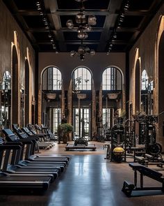 an empty gym with rows of exercise equipment