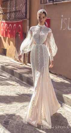 a woman is walking down the street wearing a dress with long sleeves and an embellished neckline