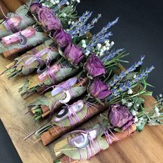 several pairs of shoes are lined up on a table with purple flowers and lavenders