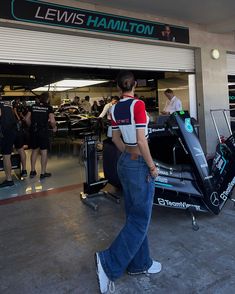 a man standing in front of a racing car