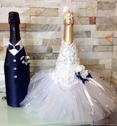 a wine bottle and tutule are sitting on a table next to a wall