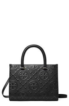 Embossed logos add signature appeal to a structured leather tote bag fitted with rolled top handles and an optional crossbody strap for versatile carry. Magnetic-snap closure Top carry handles; removable, adjustable crossbody strap Interior wall pocket Structured silhouette with flat base for stability Lined Leather Imported T Monogram, Tory Burch Tote, Tory Burch Bag Totes, Convertible Crossbody Bag, Laptop Bag For Women, Monogram Tote Bags, Womens Designer Handbags, Designer Totes, Monogram Tote