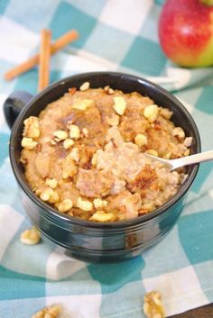 a bowl filled with oatmeal and nuts on top of a checkered table cloth