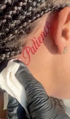 a woman with the word believe written on her ear