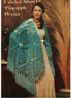 a woman wearing a blue crocheted shawl