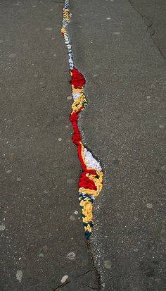 a street that has been torn apart and is painted red, white, and blue