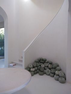 there is a pile of donuts on the floor next to a spiral stair case