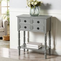 a gray table with drawers and flowers on top