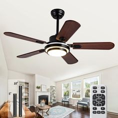 a ceiling fan in the middle of a living room with wood flooring and white walls