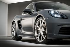 the front end of a silver sports car with its lights on and headlamps on