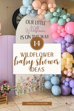 the wildflower baby shower ideas sign is displayed in front of balloons and streamers