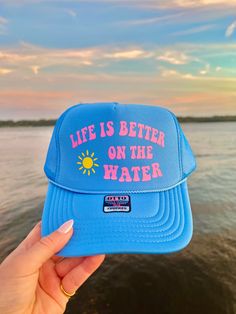 This adjustable OTTO trucker hat is so cute for summer time, it is adjustable and super comfy! It reads "Life is better on the water" in pink vinyl with a sunshine detail!! 🫶 Blue Trucker Hat, Ocean Inspired Jewelry, Custom Trucker Hats, Pink Vinyl, Hat Patches, Hat Ideas, Neat Ideas, Ocean Inspired, Jacksonville Fl