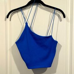 Size L Color Blue New With Tag Crop Top With Tiny Spaghetti Straps. 95% Cotton And 5% Elastane (Spandex) Blue Crop Top With Built-in Bra And Spaghetti Straps, Chic Blue Seamless Tank Top, Blue Fitted Seamless Crop Top, Fitted Blue Seamless Crop Top, Trendy Blue Spaghetti Strap Tank Top, Fitted Seamless Blue Crop Top, Blue Seamless Cami Tank Top, Blue Camisole Crop Top With Straps, Blue Seamless Sleeveless Crop Top