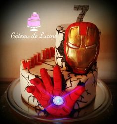 a birthday cake decorated with iron man's hands