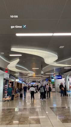 many people are walking through an airport terminal