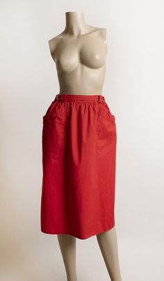 FREE DOMESTIC SHIPPING! <3♥ Adorable vintage 1970s cherry red cotton skirt with front pockets and D-ring waistline! ♥ Nylon zipper in the back with a button closure. ♥ Cute deep, front pockets. ♥ Knee length, straight style cut. ♥ Fun D-ring waistline, lets you cinch the waist in if needed. Ends of strips will lay to the side (modeled to the back to show details)♥ In great condition! Minimal wear (possibly from iron?) on seams. Cotton, made in Belgium! * measurements *Waist - 26", could cinch Red High-waist Skirt With Elastic Waistband, Red High Waist Skirt With Elastic Waistband, High Waist Red Skirt With Elastic Waistband, Red High Waist Skirt With Elastic Band, Red Spring Skirt With Pockets, Red Skirt With Pockets For Spring, Retro Red Summer Skirt, Long Red Skirt With Pockets, Red Cotton Lined Skirt