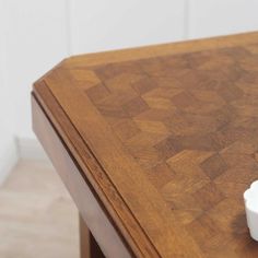 an empty cup sitting on top of a wooden table