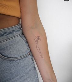 a woman's arm with a small tattoo on the left side of her arm