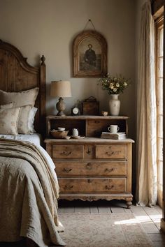 a bed sitting next to a wooden dresser in a bedroom under a painting on the wall