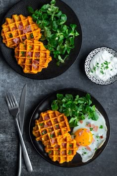 two plates with waffles and eggs on them