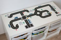 a white table with cars and roads painted on it