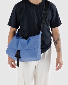 A functional, go-to bag with two large exterior pockets in addition to the main interior compartment. Has an interior laptop sleeve with velcro closure that fits 13/14” laptop in a puffy case. Bag Dimensions: 10 in. H x 14.5 in. W x 4.5 in. D Exterior Front Slip Pockets (x2) : 7.5 in H x 8 in. W Interior Back Computer Pocket: 14.5 in. W (Fits a 13/14" computer in our Puffy Sleeve) Adjustable Strap: 45 in Machine wash cold Body: 100% Nylon (59% Recycled) / Lining: 100% Nylon (40% Recycled) Have a question? Email us All items are FINAL SALE. Vintage pieces are pre-loved and may come with minor flaws, condition will be noted in description. For questions or concerns, please Email us at hello@shopbanshee.com. If purchasing through Meta all policies still ap Baggu Bags, Scrap Material, Winter Blankets, Insulated Lunch Bags, Beauty Body, Reusable Bags, Shopper Bag, Wash Bags, Tote Backpack