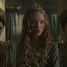 three women wearing crowns and gowns in the movie game of thrones, with one woman looking at the camera