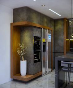 a modern kitchen with stainless steel appliances and marble counter tops, along with a dining room table